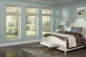 Casement windows let light into in large bedroom.